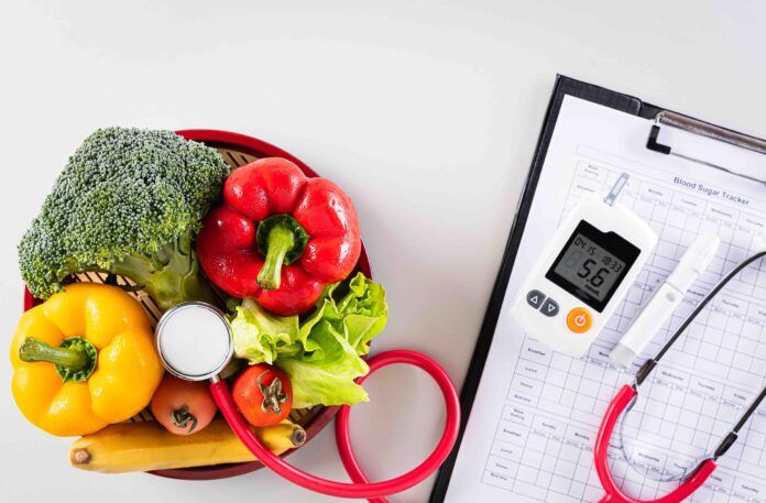 World diabetes day and healthcare concept. Patient's blood sugar control, diabetic measurement, and healthy food eating nutrition on gray background.